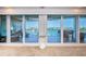 Balcony with expansive sliding glass doors offering breathtaking waterfront views and seamless indoor-outdoor living at 3805 Gulf Blvd # 504, St Pete Beach, FL 33706