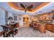 This wet bar area includes custom cabinets with glass doors, granite countertop, and a view into the bedroom at 3805 Gulf Blvd # 504, St Pete Beach, FL 33706