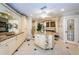 A luxurious bathroom showcases dual vanities, an island, granite countertops, and travertine floors at 3805 Gulf Blvd # 504, St Pete Beach, FL 33706