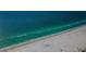 Breathtaking aerial view of a pristine white sand beach meeting crystal-clear turquoise waters at 3805 Gulf Blvd # 504, St Pete Beach, FL 33706