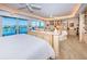 Expansive main bedroom with sitting area, custom built-ins, and balcony access with waterfront views at 3805 Gulf Blvd # 504, St Pete Beach, FL 33706