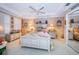 This bedroom features a charming design with a ceiling fan, bedside tables, and plentiful decorative items at 3805 Gulf Blvd # 504, St Pete Beach, FL 33706