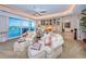 Bedroom sitting area features plush seating, custom cabinetry, and access to a waterfront balcony at 3805 Gulf Blvd # 504, St Pete Beach, FL 33706