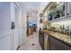 Butler's pantry with a wine refrigerator and custom cabinetry, ideal for storing glassware and beverages at 3805 Gulf Blvd # 504, St Pete Beach, FL 33706