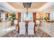 Formal dining room boasts a designer chandelier, custom rug, and elegant furnishings perfect for hosting guests at 3805 Gulf Blvd # 504, St Pete Beach, FL 33706