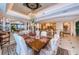 Open dining room with decorative ceiling, chandelier, with a partial view of kitchen and water at 3805 Gulf Blvd # 504, St Pete Beach, FL 33706