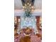 Elegantly designed dining room featuring decorative ceiling and luxurious chandelier with coral accents on table at 3805 Gulf Blvd # 504, St Pete Beach, FL 33706