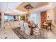 Elegant dining room with designer rug, chandelier, and decorative ceiling, perfect for hosting formal gatherings at 3805 Gulf Blvd # 504, St Pete Beach, FL 33706