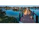 Waterfront view of a well-maintained wooden dock extending into clear blue water at 3805 Gulf Blvd # 504, St Pete Beach, FL 33706