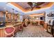 Spacious game room featuring a bar area, game table, and unique ceiling design at 3805 Gulf Blvd # 504, St Pete Beach, FL 33706