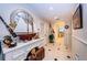 Bright hallway featuring a decorative desk, arched mirror, and neutral tiled flooring at 3805 Gulf Blvd # 504, St Pete Beach, FL 33706