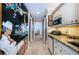 The hallway features unique murals, a convenient kitchenette, and access to a bedroom beyond at 3805 Gulf Blvd # 504, St Pete Beach, FL 33706