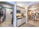 Hallway featuring a kitchenette and a closet, leading to the primary bathroom at 3805 Gulf Blvd # 504, St Pete Beach, FL 33706