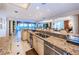 Open-concept kitchen with a large island, stainless steel appliances, and a breakfast bar flows into the living area at 3805 Gulf Blvd # 504, St Pete Beach, FL 33706