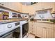 An organized laundry area with newer model washer/dryer, granite countertop and decorative cabinetry at 3805 Gulf Blvd # 504, St Pete Beach, FL 33706