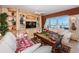 Open living room with built-in shelves, large windows, and comfortable seating arrangement at 3805 Gulf Blvd # 504, St Pete Beach, FL 33706