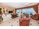 Bright living room featuring elegant furnishings and expansive windows overlooking the water at 3805 Gulf Blvd # 504, St Pete Beach, FL 33706