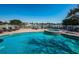 Inviting pool and hot tub surrounded by comfortable loungers and serene waterfront views at 3805 Gulf Blvd # 504, St Pete Beach, FL 33706