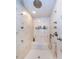 Luxurious shower offers multiple shower heads, a built in bench, and designer tile at 3805 Gulf Blvd # 504, St Pete Beach, FL 33706