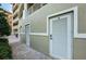 Exterior storage with light green walls and brick-paved walkway, offering practical space at 3805 Gulf Blvd # 504, St Pete Beach, FL 33706