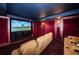 Home theater room with oversized screen, comfortable seating, and custom lighting for an immersive experience at 3805 Gulf Blvd # 504, St Pete Beach, FL 33706