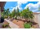 A landscaped backyard with brick paver patio, seating, mature landscaping, and fencing at 3877 Burdick Loop, Odessa, FL 33556