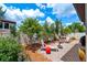 A landscaped backyard with brick paver patio, lounge chairs, and mature landscaping at 3877 Burdick Loop, Odessa, FL 33556