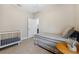 Comfortable bedroom with a crib, neutral paint, tile flooring, and bright window to enhance the home's appeal at 3877 Burdick Loop, Odessa, FL 33556