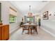 Open-concept dining room featuring a wood table and contemporary lighting at 3877 Burdick Loop, Odessa, FL 33556