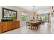Open-concept dining room and living room with lots of natural light at 3877 Burdick Loop, Odessa, FL 33556