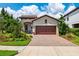 Charming single-story home with a beautiful paver driveway and manicured landscaping at 3877 Burdick Loop, Odessa, FL 33556
