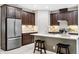 Modern kitchen with stainless steel appliances, a large island, and stylish dark wood cabinetry at 3877 Burdick Loop, Odessa, FL 33556