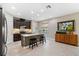 Modern kitchen with stainless steel appliances, island with seating and stylish dark cabinetry at 3877 Burdick Loop, Odessa, FL 33556