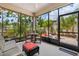 Screened lanai with comfortable seating and views of landscaped backyard at 3877 Burdick Loop, Odessa, FL 33556