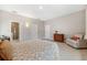 Spacious primary bedroom with tile flooring and en suite bathroom at 3877 Burdick Loop, Odessa, FL 33556