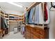 Spacious walk-in closet with custom shelving and drawers for optimal organization and storage solutions at 3877 Burdick Loop, Odessa, FL 33556