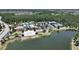 Aerial view of community amenities including pool, tennis courts, parking and clubhouse at 4063 Medicci Ln, Wesley Chapel, FL 33543