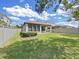 Fenced backyard with healthy green grass, landscaping and a covered patio at 4063 Medicci Ln, Wesley Chapel, FL 33543