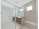 Well-lit bathroom with neutral tones featuring a glass enclosed shower and double vanity at 4063 Medicci Ln, Wesley Chapel, FL 33543