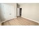 Bedroom features wood floor, closet with double doors, and a door open to another room at 4063 Medicci Ln, Wesley Chapel, FL 33543