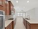 Modern kitchen featuring stainless steel appliances, wood cabinetry, and a tile backsplash at 4063 Medicci Ln, Wesley Chapel, FL 33543