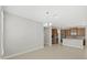 Spacious, open concept living room adjoins modern kitchen area with stainless steel appliances and island at 4063 Medicci Ln, Wesley Chapel, FL 33543
