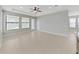 Spacious living room featuring tile floors, neutral walls, ceiling fan and lots of natural light at 4063 Medicci Ln, Wesley Chapel, FL 33543