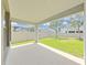Covered patio with concrete flooring, looking out to a fenced yard at 4063 Medicci Ln, Wesley Chapel, FL 33543