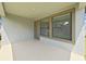 Covered patio with concrete flooring, windows and glass door at 4063 Medicci Ln, Wesley Chapel, FL 33543