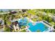 Aerial view of resort-style pool with slides, lounge chairs, and well-maintained landscaping at 4063 Medicci Ln, Wesley Chapel, FL 33543