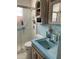 Bathroom featuring walk-in shower, tile floors and walls, and blue sink at 4104 W North B St, Tampa, FL 33609
