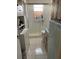 Bathroom featuring walk-in shower, tile floors and walls, and blue sink at 4104 W North B St, Tampa, FL 33609