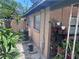 Side exterior view shows a well-maintained home with mature landscaping, an AC unit, and a peek at the backyard at 4104 W North B St, Tampa, FL 33609