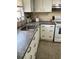 Galley kitchen with stainless steel sink, and white cabinets and drawers at 4104 W North B St, Tampa, FL 33609